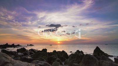 Sea sunset on rock shore pan time lapse