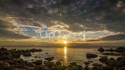 Sunset on sea in rocks bay time lapse