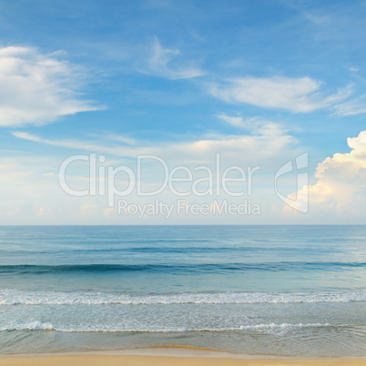 ocean, sandy beach and blue sky