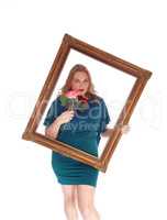 Woman looking trough picture frame