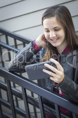 Pretty Young Girl Looking at Smart Phone