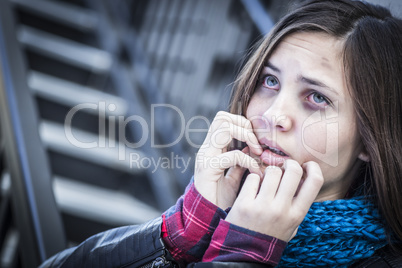 Young Bruised and Frightened Girl on Staircase