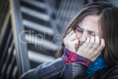 Young Crying Teen Aged Girl on Staircase