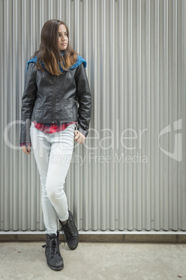 Young Teen Girl Standing Against Metal Wall