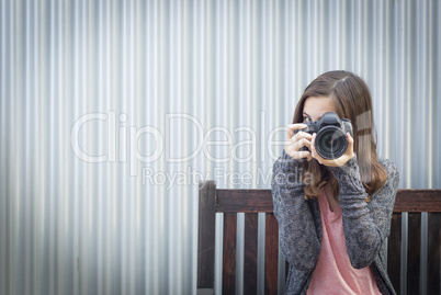 Girl Photographer Sitting and Pointing Camera