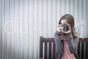 Girl Photographer Sitting and Pointing Camera