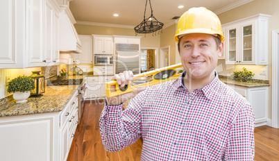 Contractor with Level Wearing Hard Hat Standing In Custom Kitche