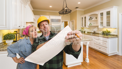 Contractor Discussing Plans with Woman Inside Custom Kitchen Int