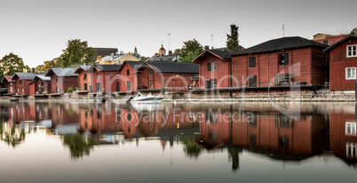 Red shore houses on the riverbank of Porvoo river. Porvoo, Finland