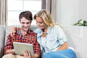 Couple using tablet computer
