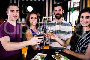 Group of friends toasting with a glass of wine