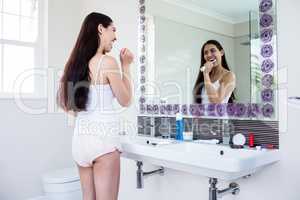 Brunette brushing teeth