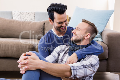 Gay couple hugging on the couch