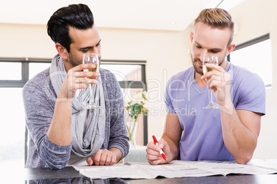 Smiling gay couple surrounding ads