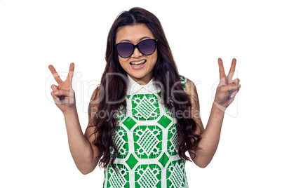 Asian woman making peace sign with hands