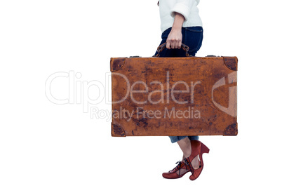 Midsection of woman holding luggage