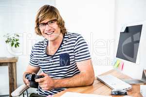 Smiling hipster businessman checking photo on camera