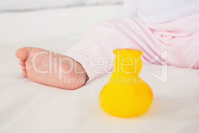 Close up of baby foot and plastic duck