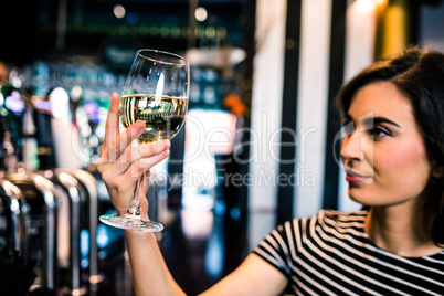 Attractive woman looking at her glass of wine