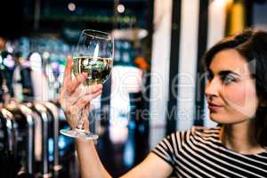 Attractive woman looking at her glass of wine