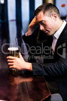 Thoughtful businessman having a beer