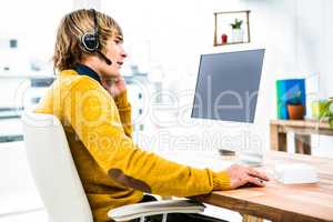 Smiling hipster businessman using headset