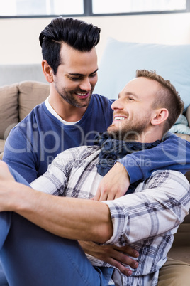 Gay couple hugging on the couch