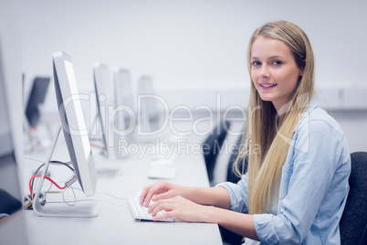 Smiling student working on computer