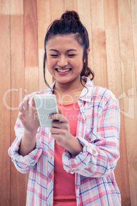 Happy Asian woman using smartphone