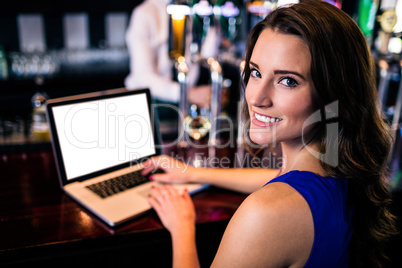 Portrait of woman using laptop