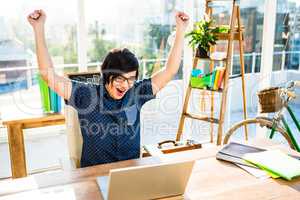 Cheerful asian businessman using laptop