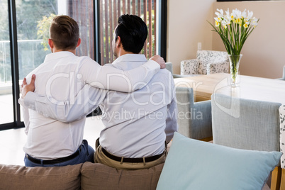 Rear view of gay couple with arms around Rear view of gay couple with arms around