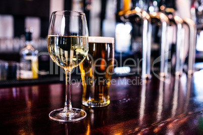 Close up of a glass of wine and a beer