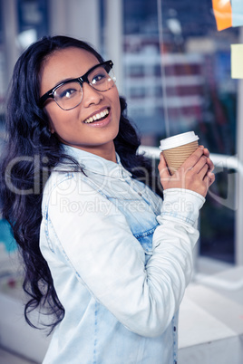 Asian woman holding disposable cup