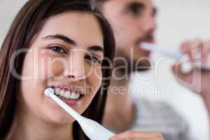 Couple brushing their teeth