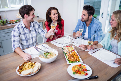 Smiling couple friends eating together