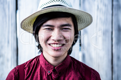 Smiling hipster with a straw hat