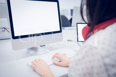 Rear view of student using computer