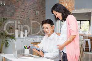 Happy couple using tablet