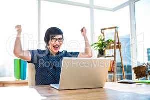Cheerful asian businessman using laptop