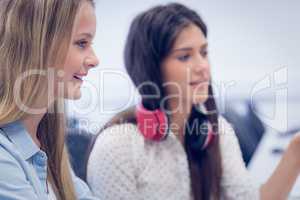 Smiling students using computer