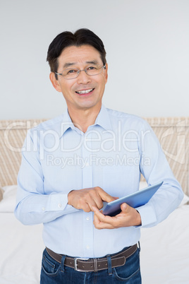 Smiling man using tablet