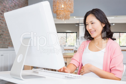 Smiling woman using computer