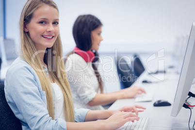 Smiling students using computer