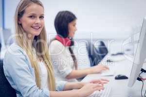 Smiling students using computer