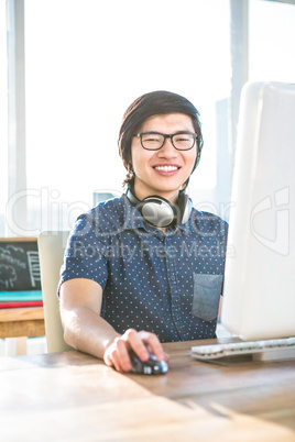 Smiling asian businessman using computer