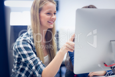 Smiling students using computer