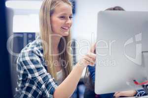 Smiling students using computer