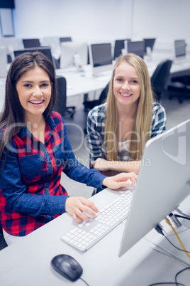 Smiling students using computer