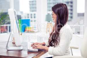Focused Asian woman on computer